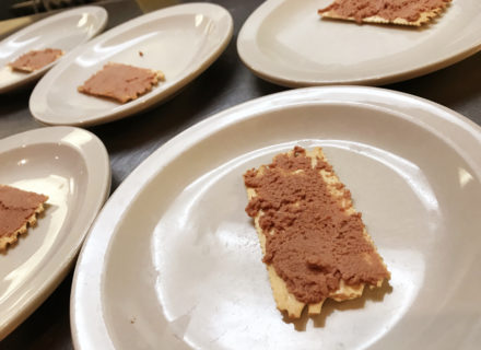 Pork liver pâté on a cracker paired with chilled dry vermouth