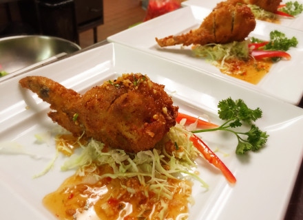 Stuffed chicken wing with sweet and sour, peanut, chili, cilantro, garlic sauce